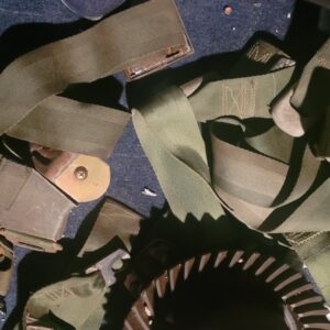 A large box full of green seat belts marked 69 and 70