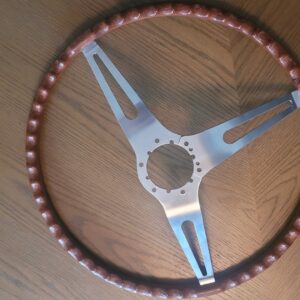 A mint 69 camaro  chevelle rosewood wheel. Zero cracks great color and swirls as all these wheels are unique.....super nice aluminum spokes. 