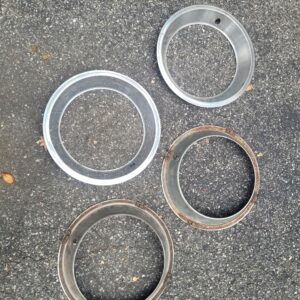 Trim rings 67 corvette and 1969 z28 15 inch oval hole  w 4 clips. Driver shape. Restored these are over 1000.00.....assembly line parts.