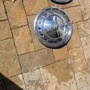 One 1957 base hub cap belair